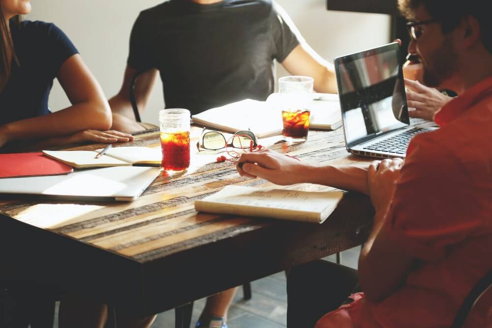 business people around table marketing strategy
